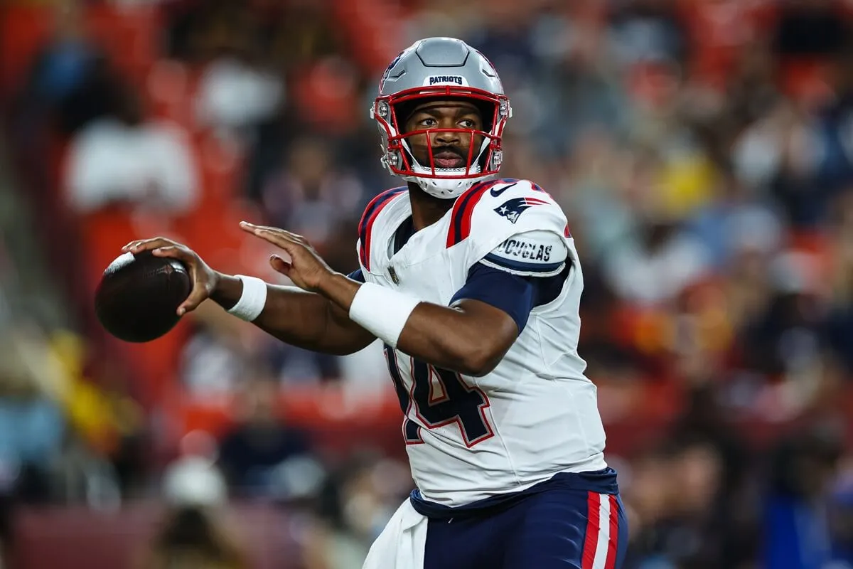 Jacoby Brissett of the New England Patriots looking to pass to a receiver in a game against the Washington Commanders