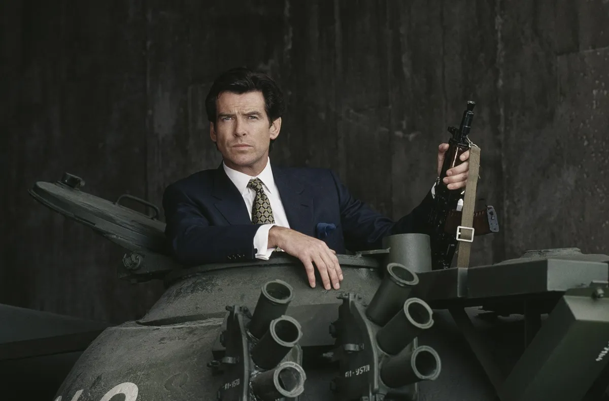 Pierce Brosnan posing as James Bond while in a tank.