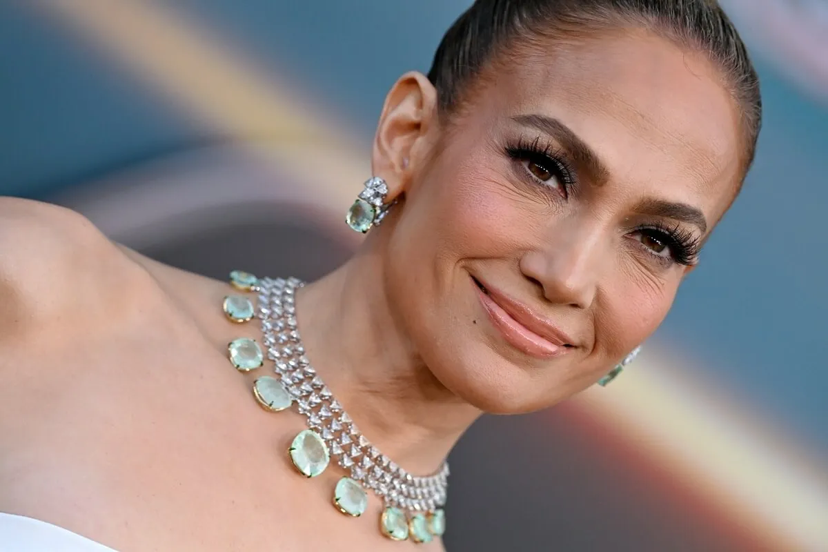 Jennifer Lopez posing in a necklace while wearing a crop top at the 'Atlas' premiere.