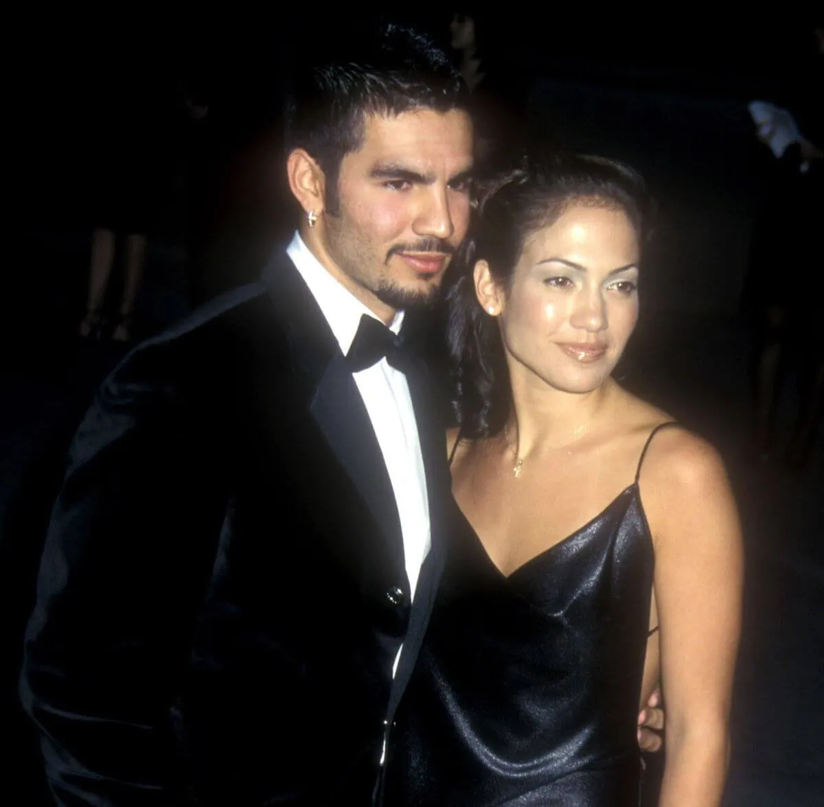 Jennifer Lopez stands with her arm around her husband, Ojani Noa. They both wear black.