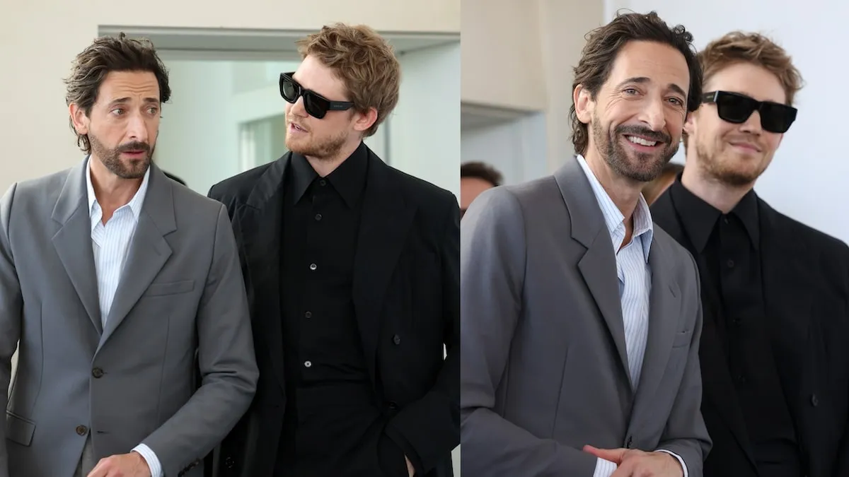 The Brutalist stars Adrien Brody and Joe Alwyn laugh together on the side of a stage at the Venice Film Festival