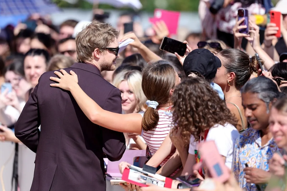 Actor Joe Alwyn takes a selfie with a fan at the Venice Film Festival