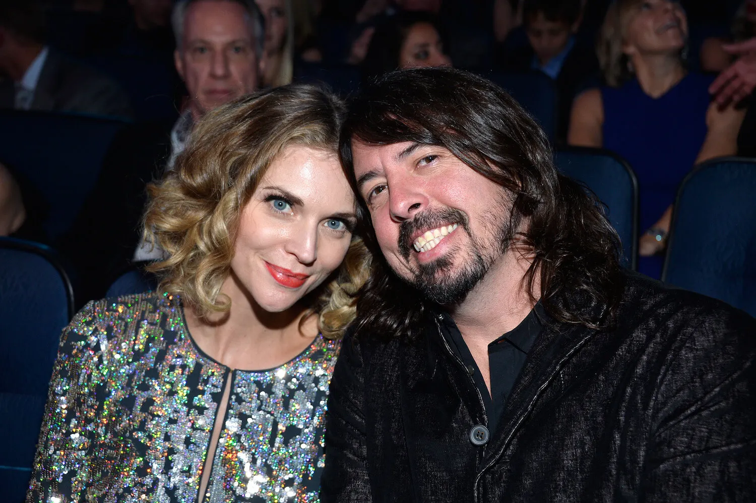 Jordyn Blum and Dave Grohl posing together while touching foreheads and smiling in 2013