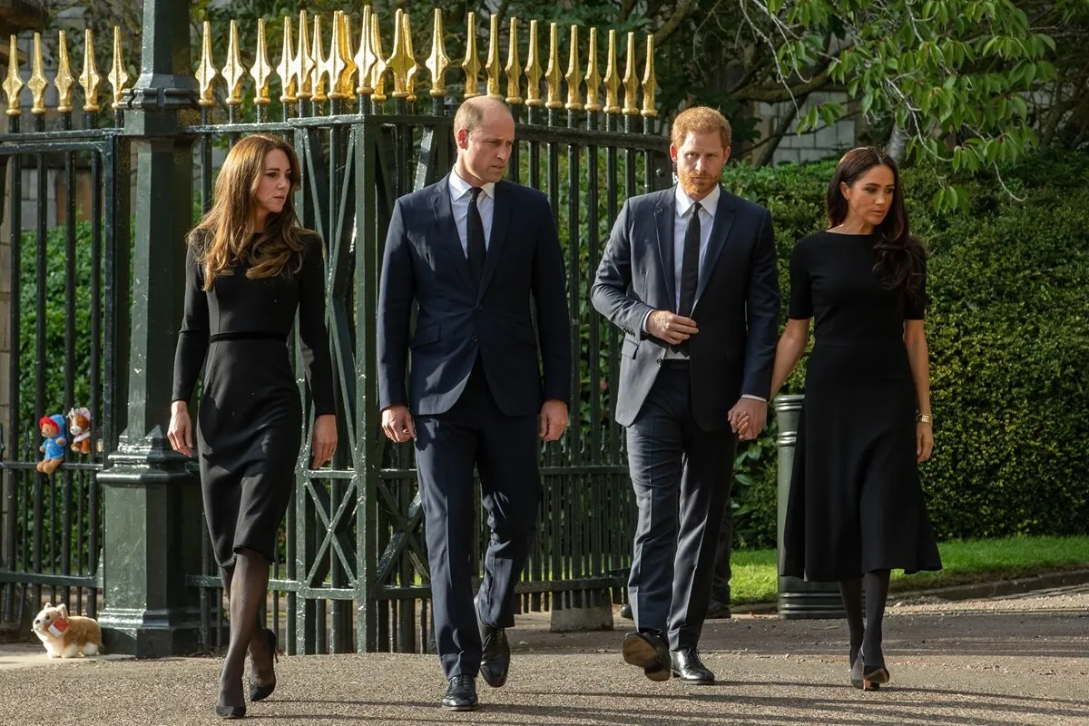 Kate Middleton, Prince William, Prince Harry, and Meghan Markle arrive to view floral tributes to Queen Elizabeth II laid outside Cambridge Gate at Windsor Castle