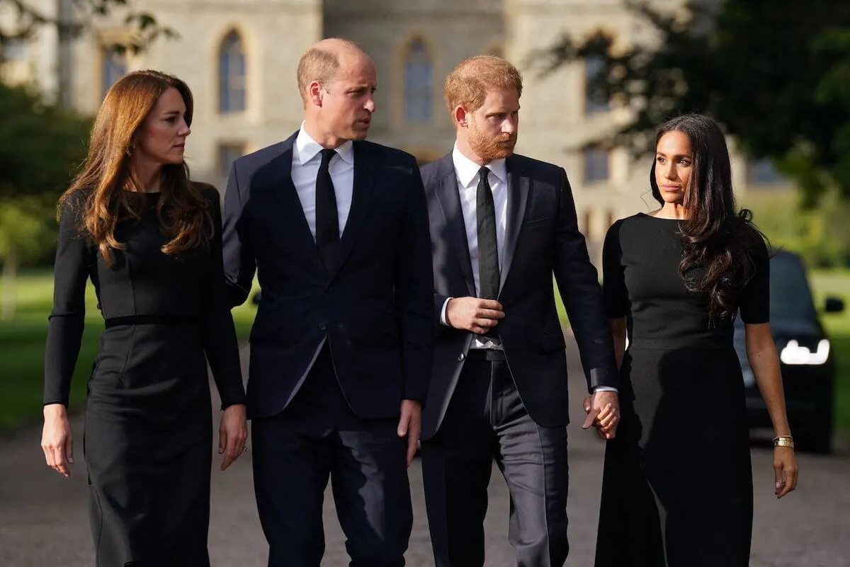 Kate Middleton, Prince William, Prince Harry, and Meghan Markle walk together.