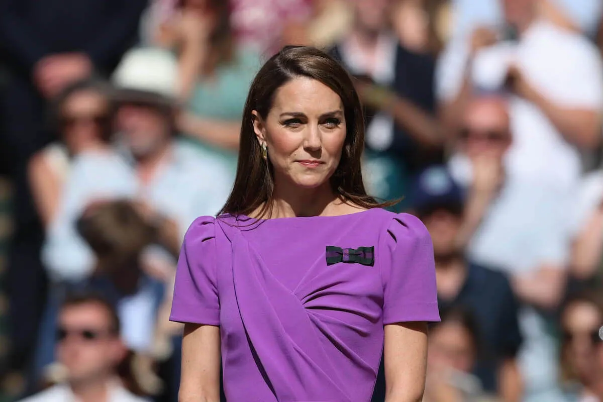 Kate Middleton, who is 'cancer free' after completing chemotherapy, looks on wearing a purple dress.