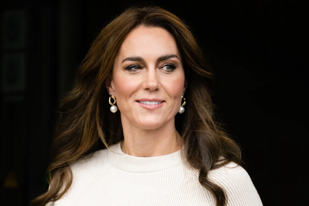 Kate Middleton, who was seen at church in Scotland, looks on wearing a white top.