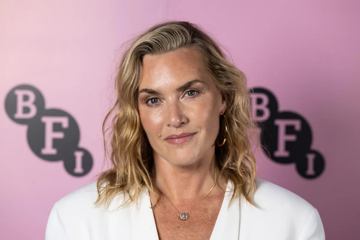 Kate Winslet, who underwent testosterone replacement therapy, looks on wearing a white blazer.