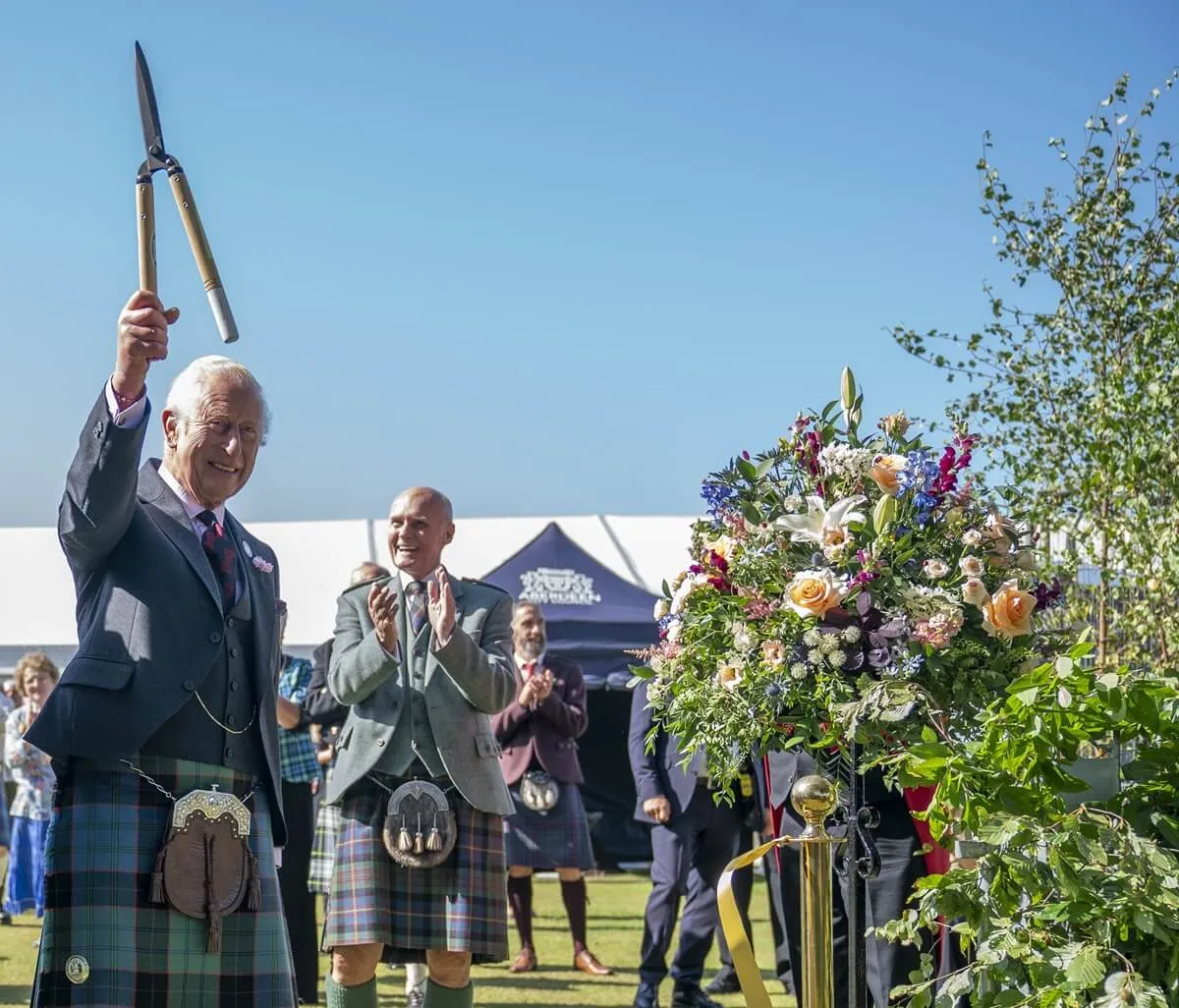 King Charles III holds up a pair of gardening shears to officially open the Royal Horticultural Society of Aberdeen's 200th Flower Show