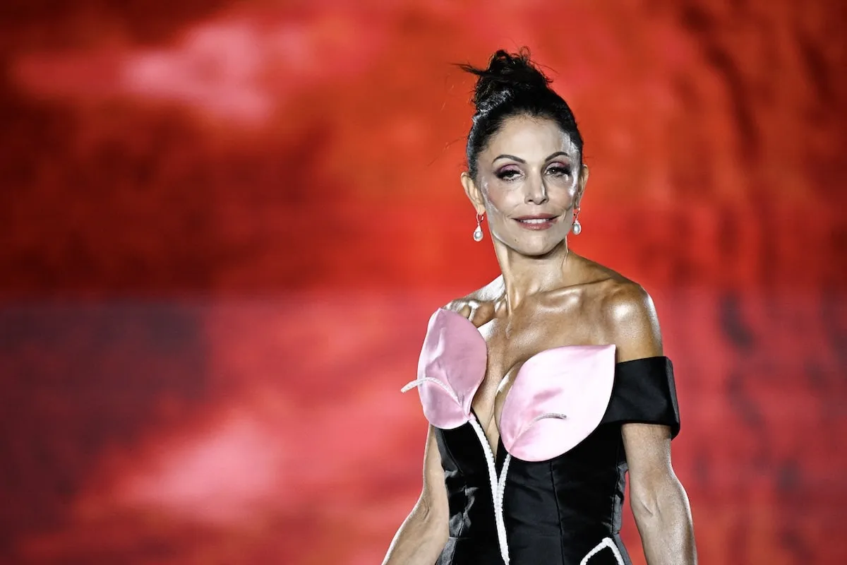 Wearing a black and pink mini dress and sky-high heels, Bethenny Frankel walks the runway in Paris for L'Oreal Paris