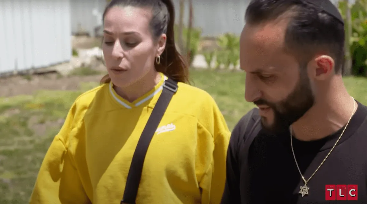 Laurie, wearing a yellow sweatshirt, and Eli, in an episode of 'Forbidden Love' on TLC