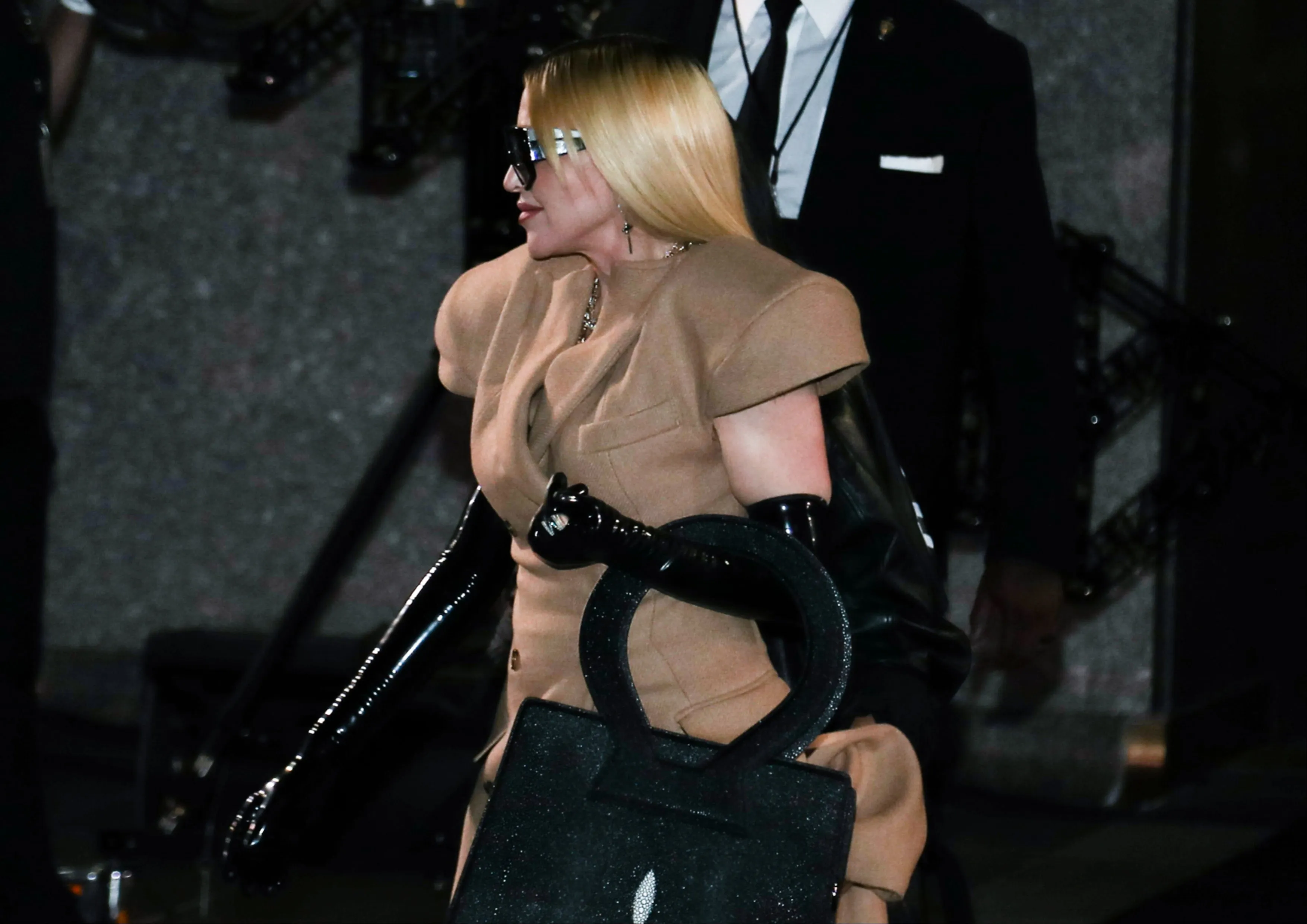 Wearing a camel coat and black leather boots, Madonna enters the Luar Fashion show during New York Fashion Week