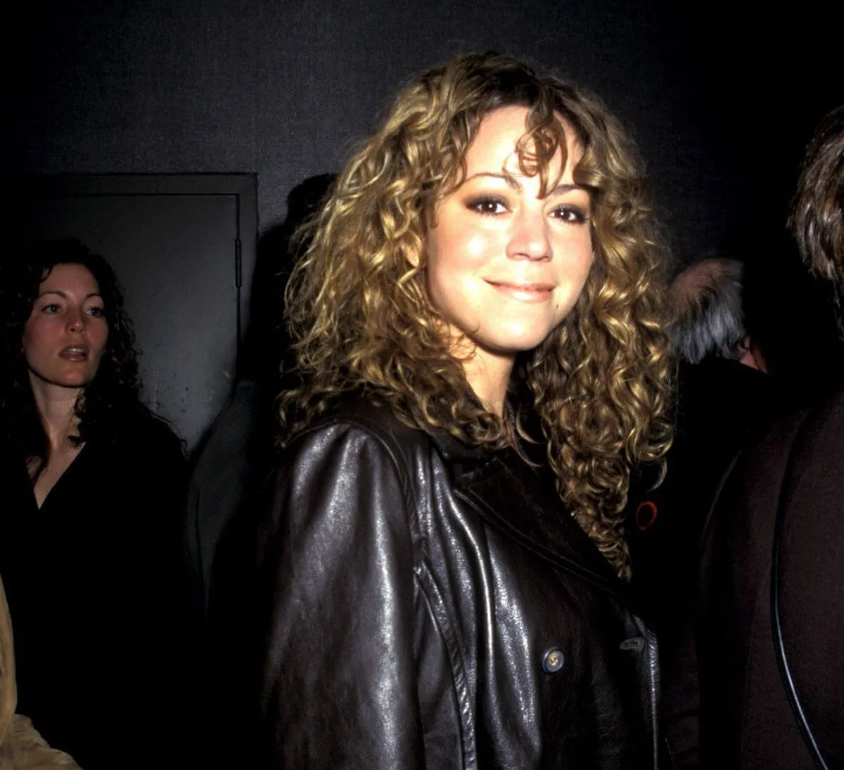 Mariah Carey wears a black leather jacket.