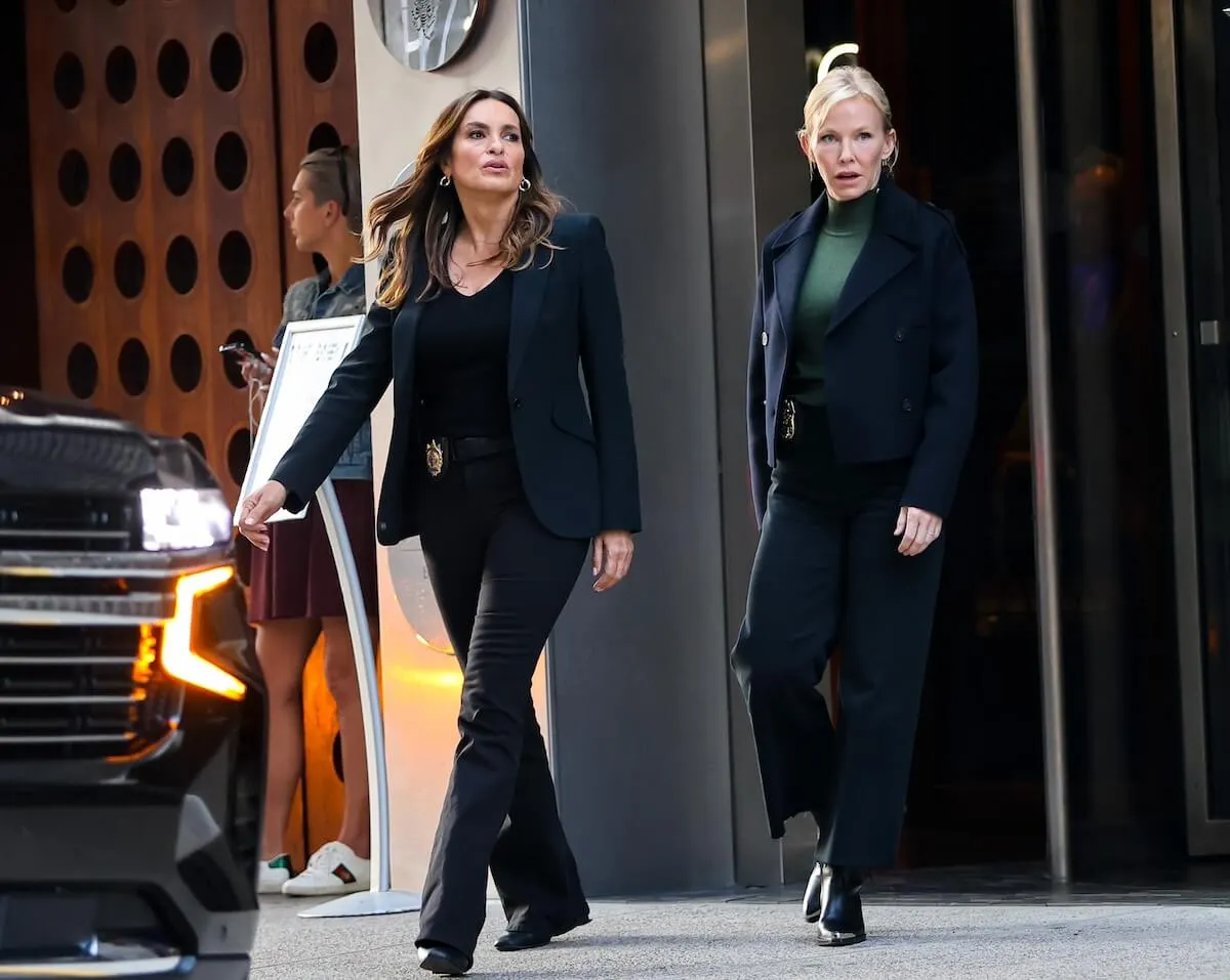 Mariska Hargitay and Kelli Giddish walking out of a building on the set of 'Law and Order: SVU' Season 26