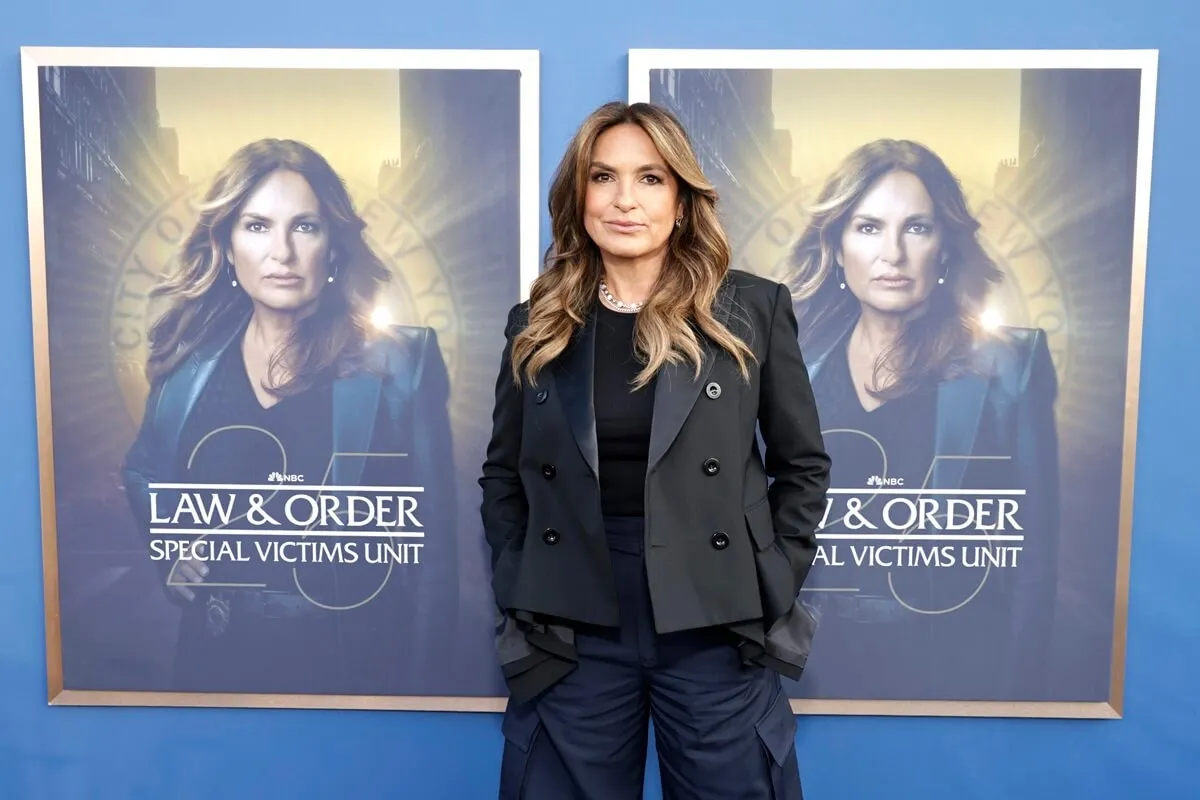 Mariska Hargitay standing in front of a 'Law & Order SVU' poster.