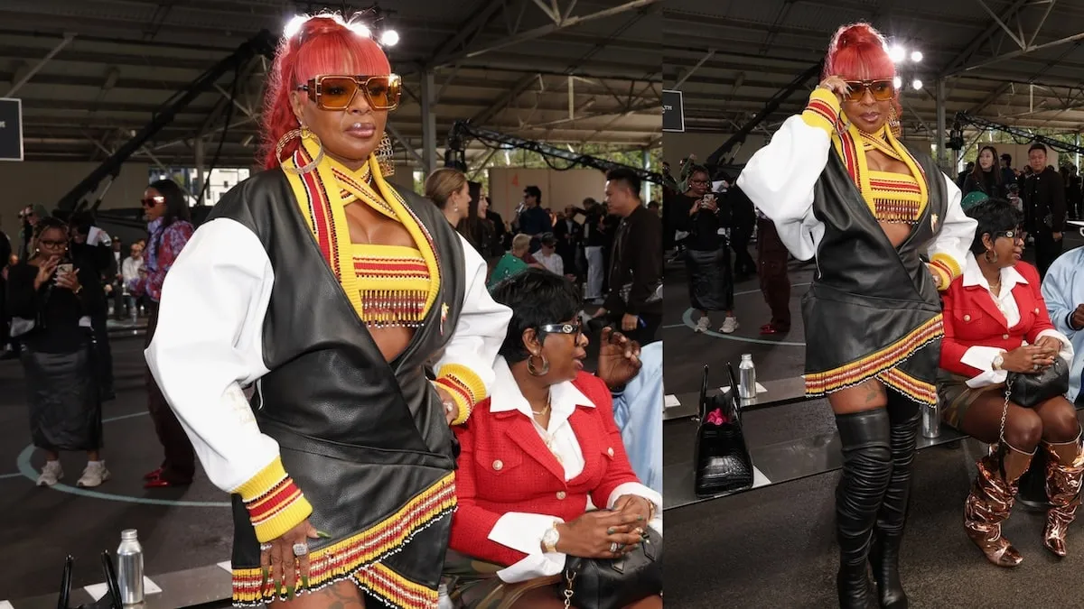 Wearing a black, white, and red leather mini dress, Mary J. Blige poses for photographers at the Off-White fashion show