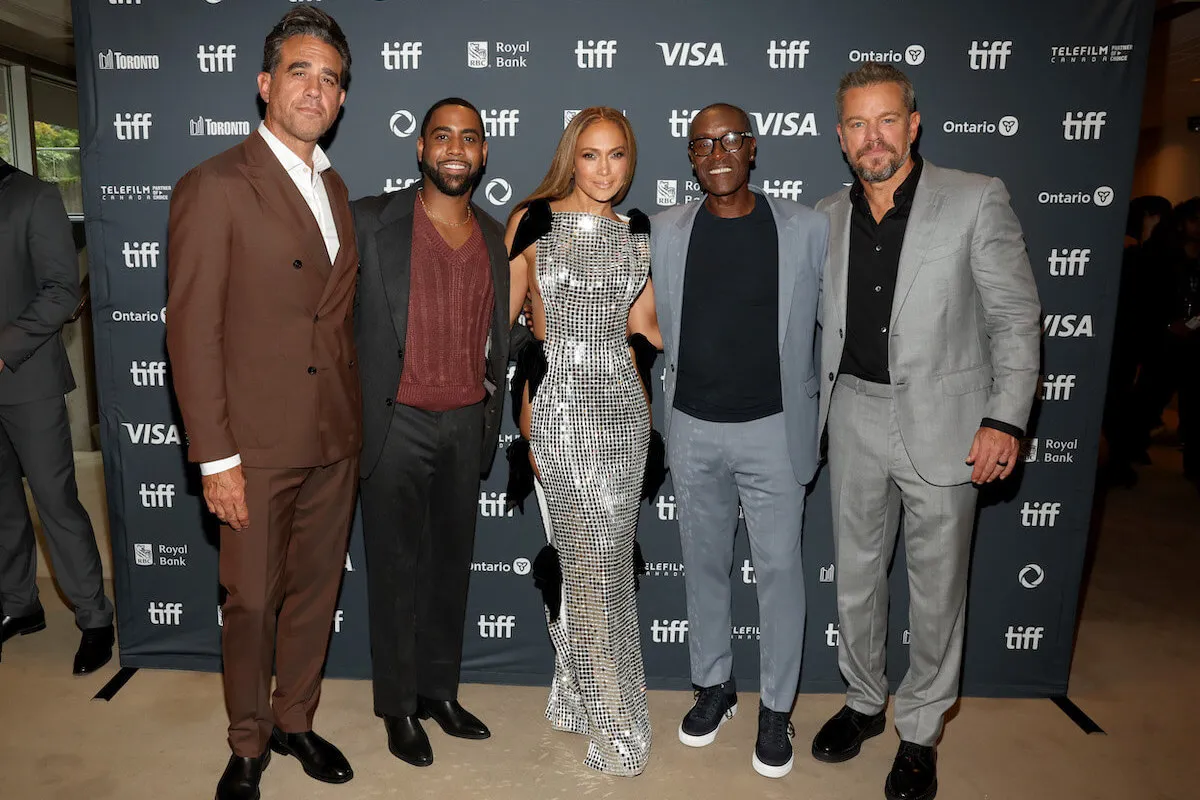 Jennifer Lopez posing in a silver dress with other stars from 'Unstoppable,' including Matt Damon