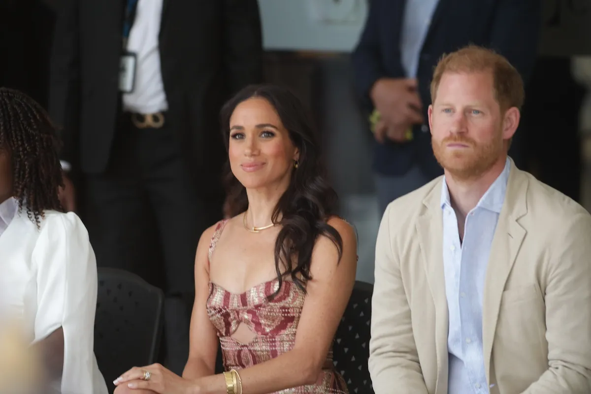 Meghan Markle and Prince Harry sitting and smiling