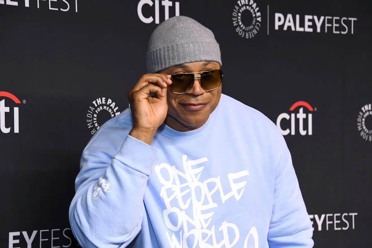 LL Cool J attends a salute to the NCIS universe celebrating "NCIS" "NCIS: Los Angeles" and "NCIS: Hawai'i" during the 39th Annual PaleyFest while wearing a blue shirt, grey hat and shades.