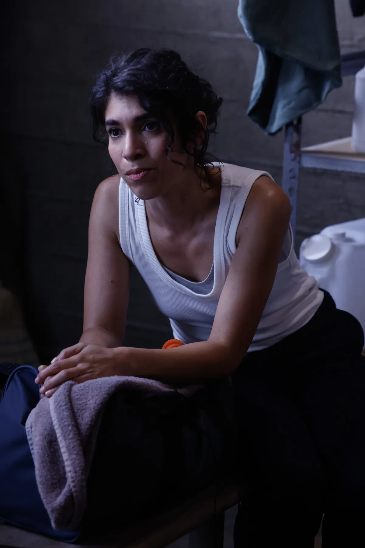 Woman in a white tank top in the 'NCIS: Origins' series premiere