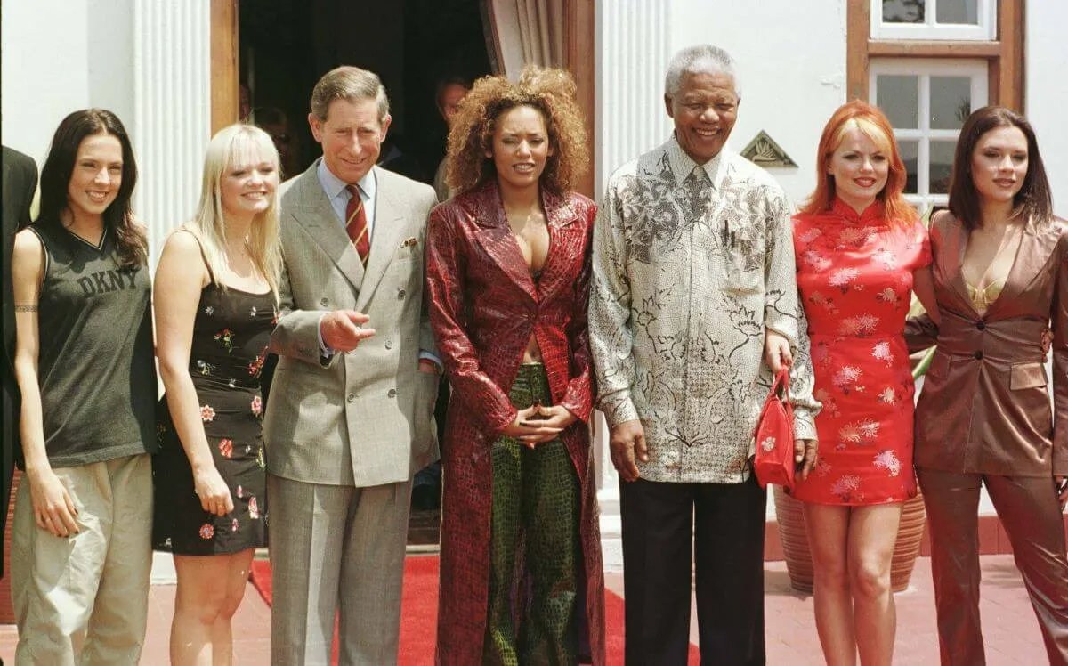 The Spice Girls stand outside with Prince Charles and Nelson Mandela.