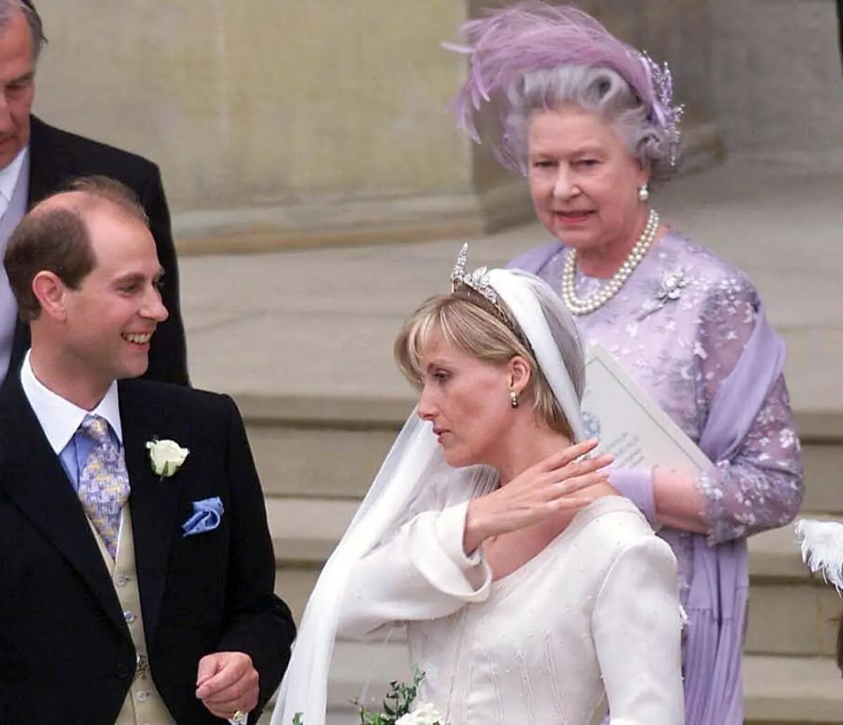 Prince Edward and then-Sophie Rhys-Jones standing outside St. George's Chapel at Windsor with Queen Elizabeth II