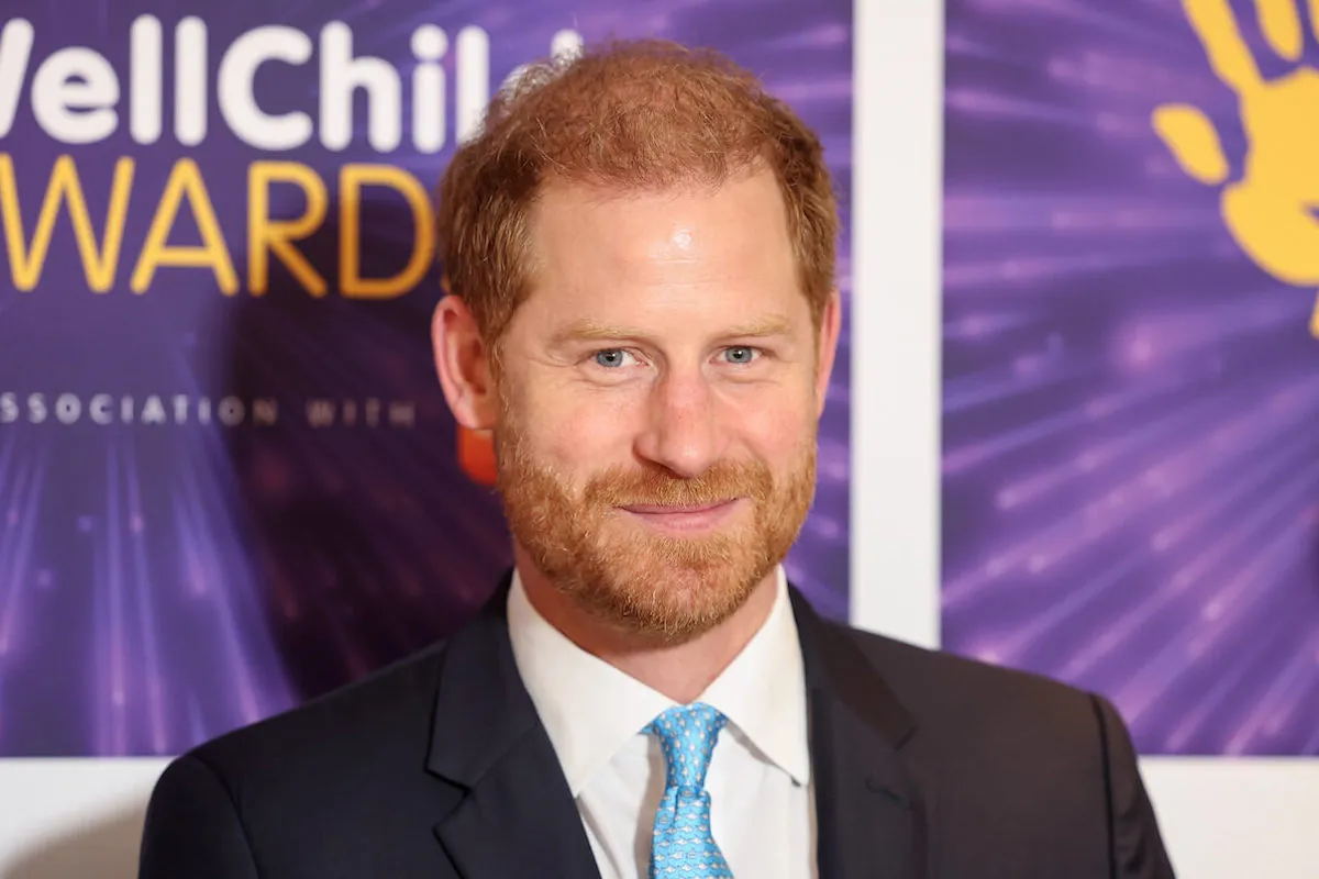 Prince Harry, who reportedly doesn't appear much in his Netflix 'Polo' documentary series, smiles wearing a suit and blue tie.