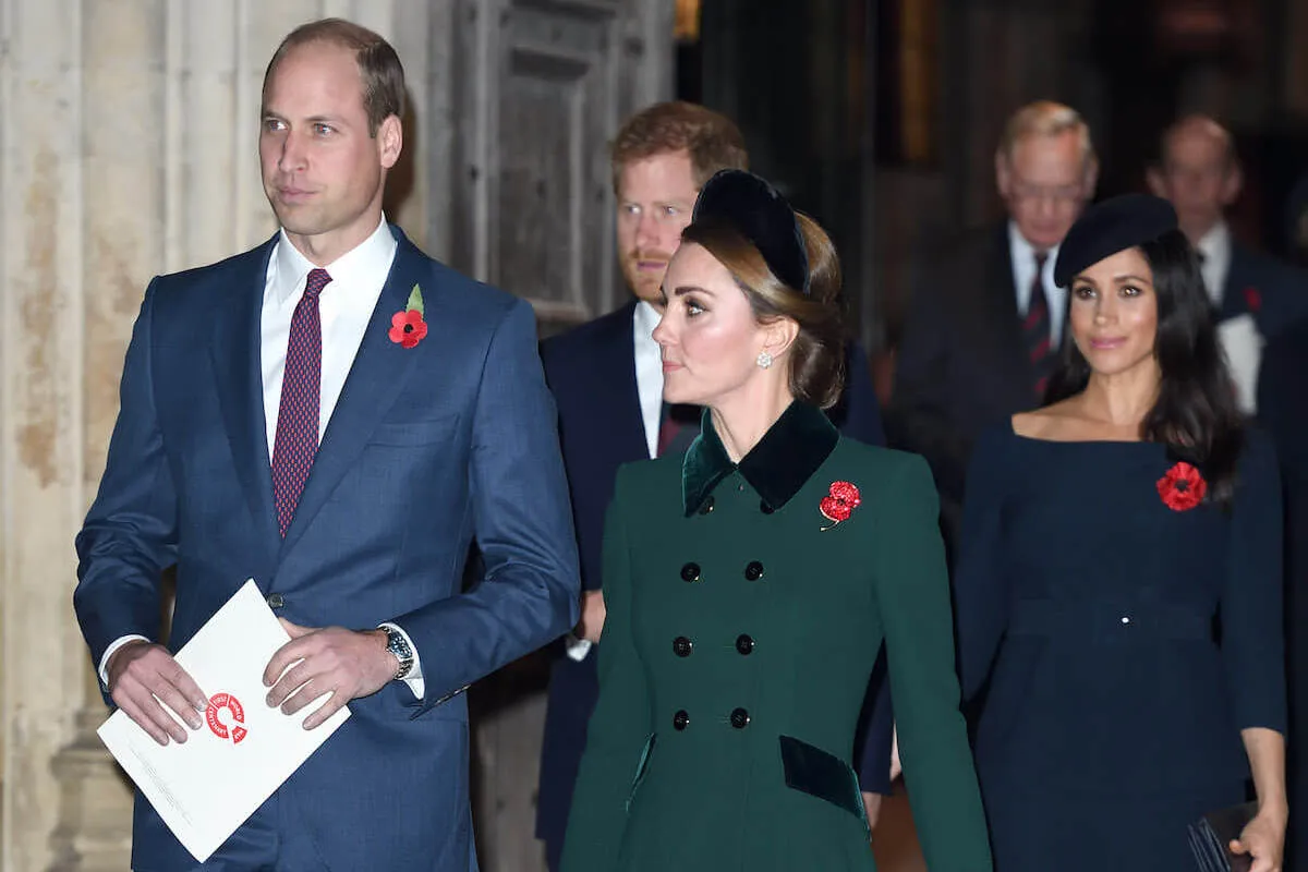 Prince William and Kate Middleton, who wished Prince Harry a happy birthday on social media, walk in front of Prince Harry and Meghan Markle 