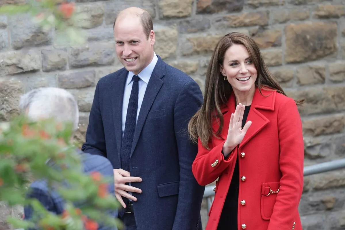 Prince William walking with Kate Middelton as she waves to well-wishers outside St. Thomas Church in Swansea, Wales