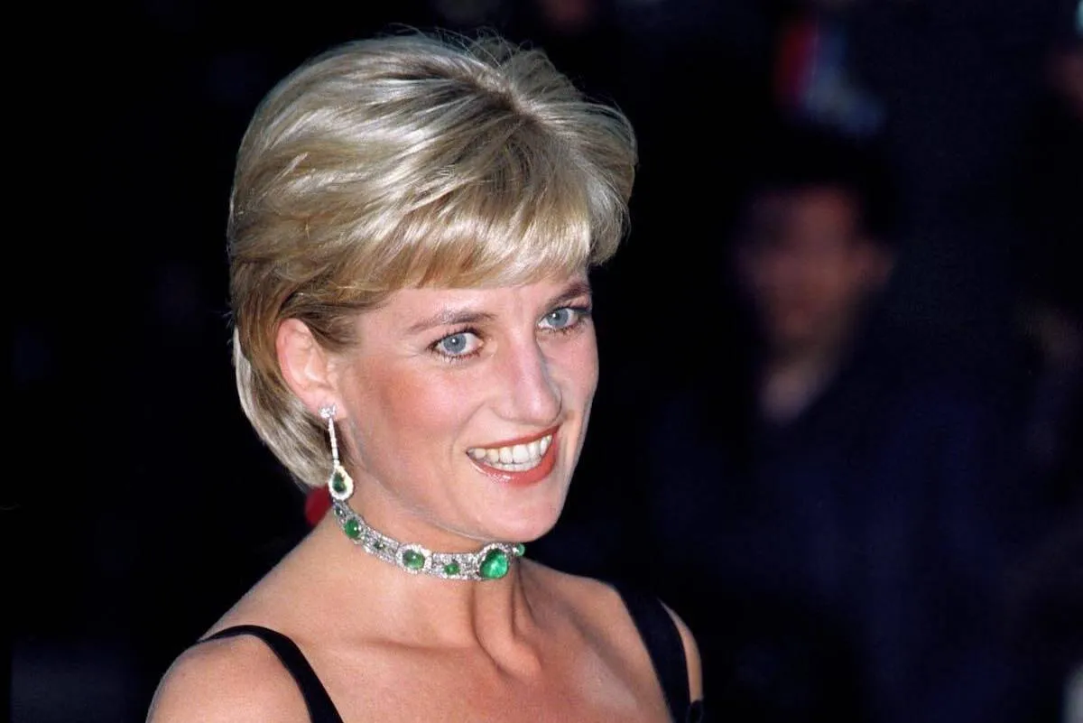 Princess Diana wears the emerald and diamond choker necklace she wore as a headband