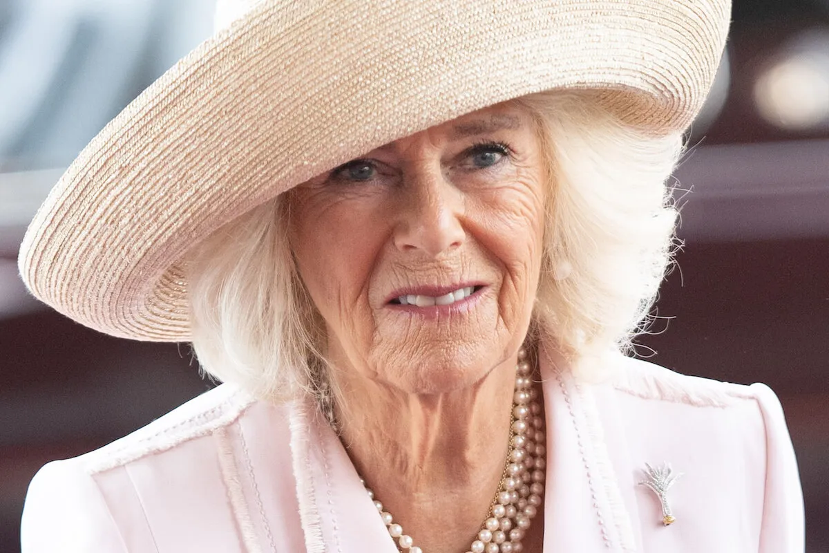 Queen Camilla, who may someday join TikTok for The Queen's Reading Room, wears a straw hat