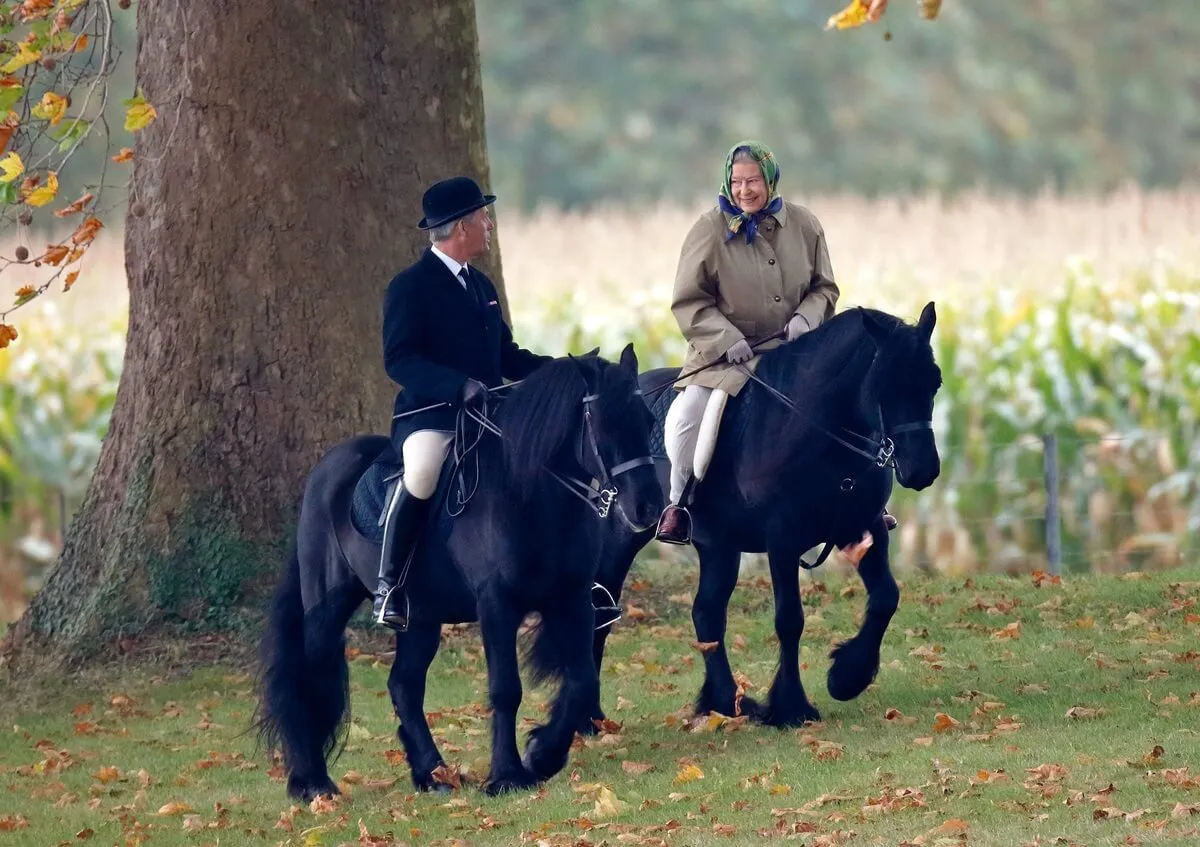 Queen Elizabeth II, accompanied by her stud groom Terry Pendry, riding horses in Windsor