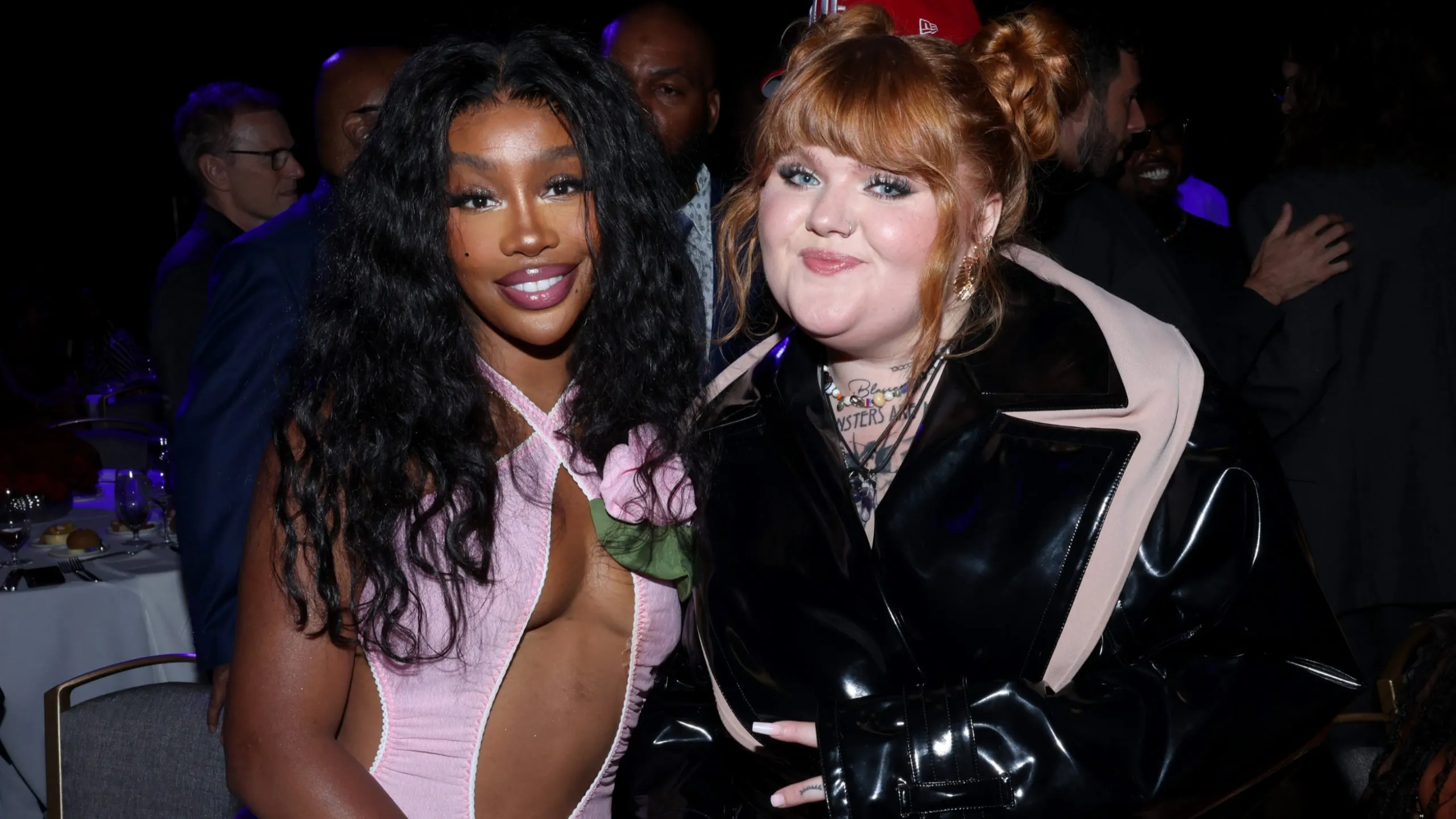 Sitting together at a table at the 2024 BMI R&B/Hip-Hop Awards, SZA and MaKenzie smile for a photo together