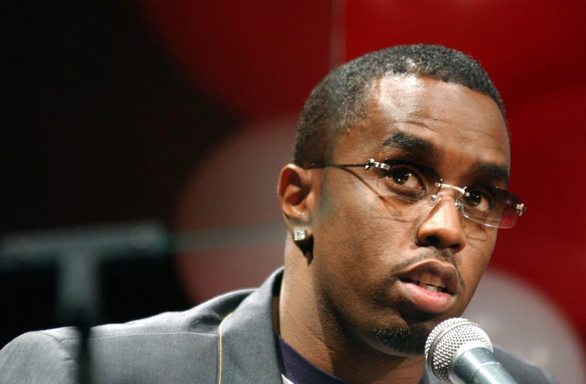 Sean 'P. Diddy' Combs looking up and speaking into a microphone