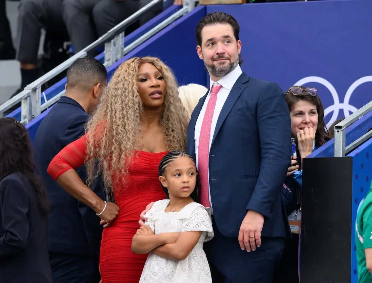 Retired athlete Serena Williams, Alexis Ohanian, and their daughter Adira River watch an event at the Paris Olympics