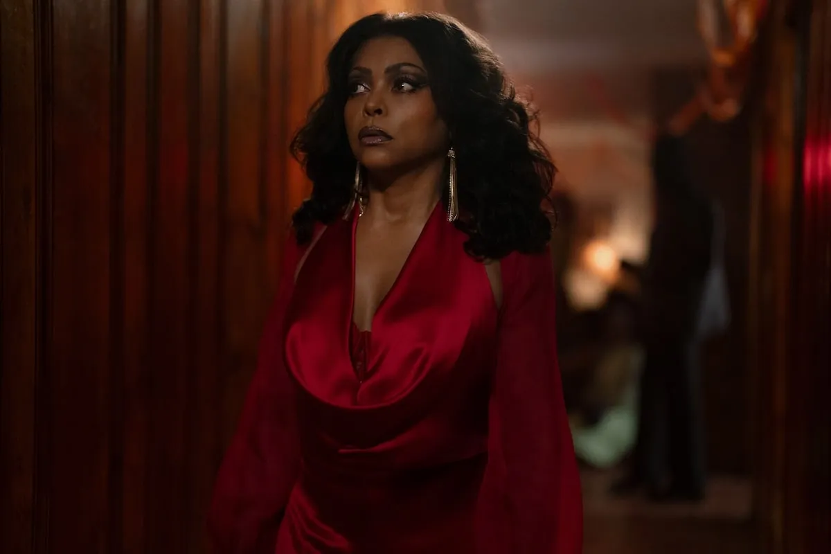 Wearing a red satin dress, Taraji P. Henson films a scene carpet for Peacock's Fight Night: The Million Dollar Heist