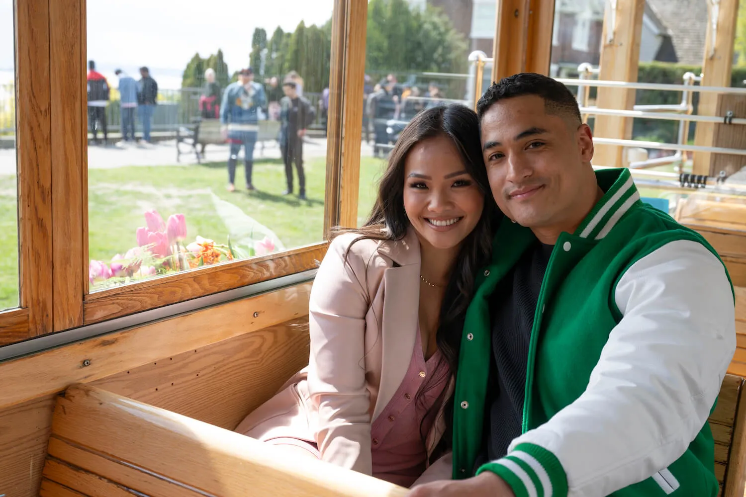 Jenn Tran and Marcus Shoberg sitting next to each other and smiling on a street car in 'The Bachelorette' Season 21