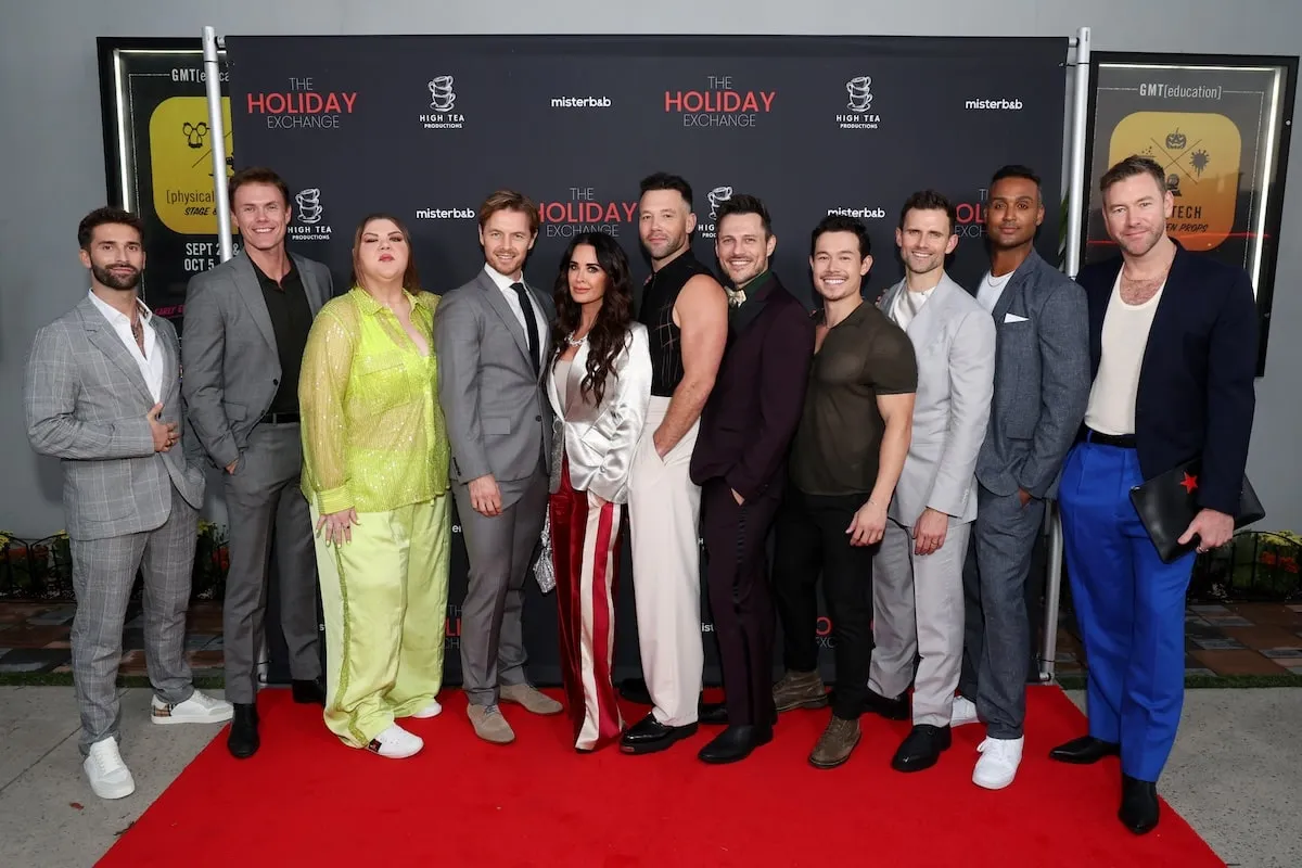 The Holiday Exchange extended cast stands together on the red carpet with Kyle Richards in the middle