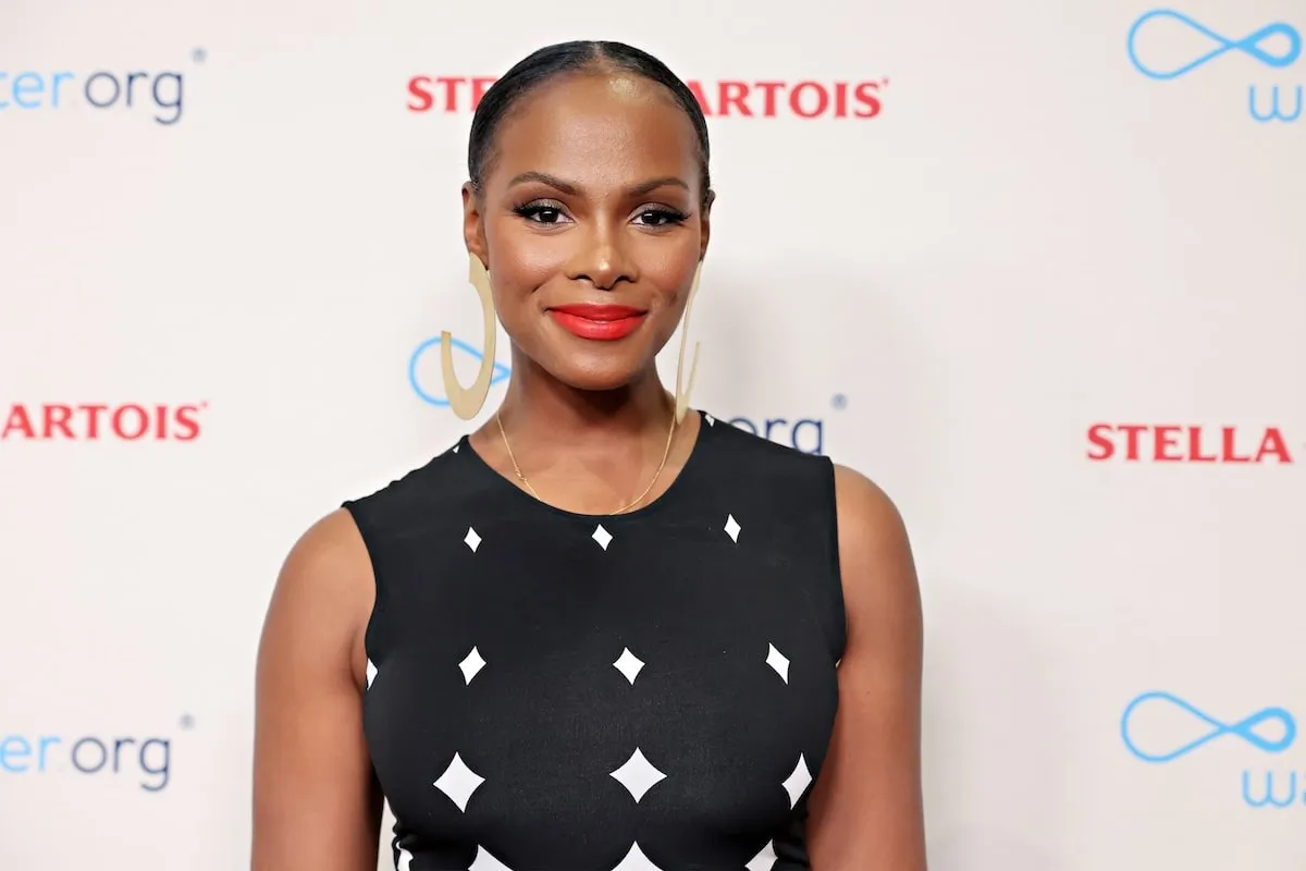 Wearing a black and white dress, Tika Sumpter poses for a photo in 2023