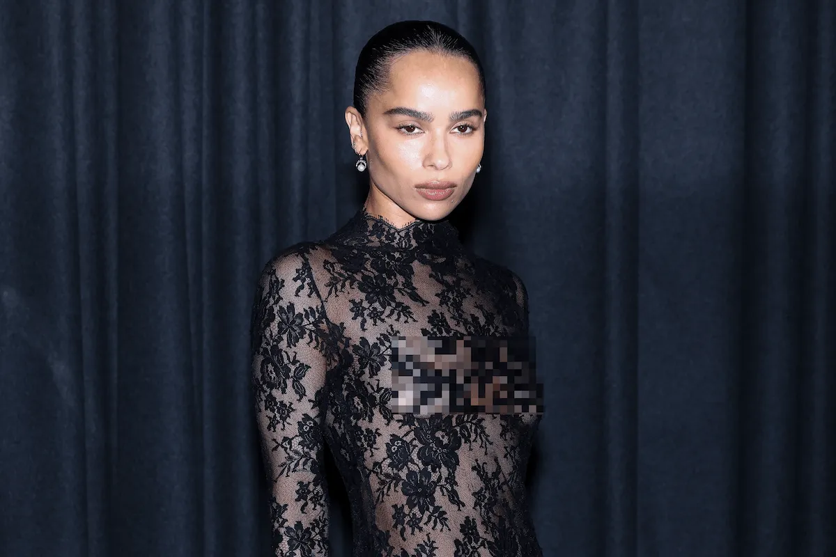 Wearing a sheer black lace mini dress, Zoe Kravitz poses for photos before the Saint Laurent Womenswear Spring-Summer 2025 show