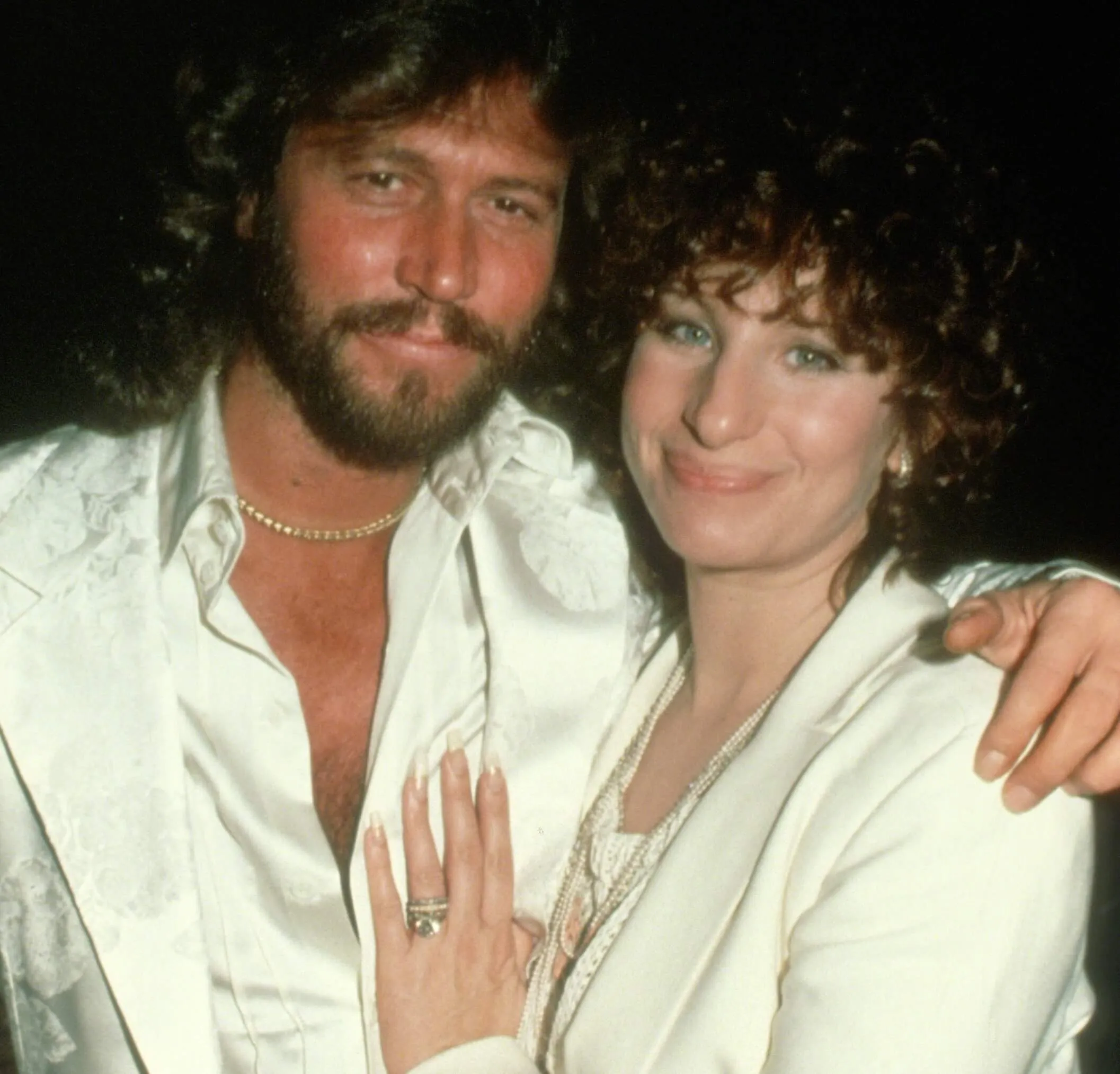 The Bee Gees' Barry Gibb holding Barbra Streisand