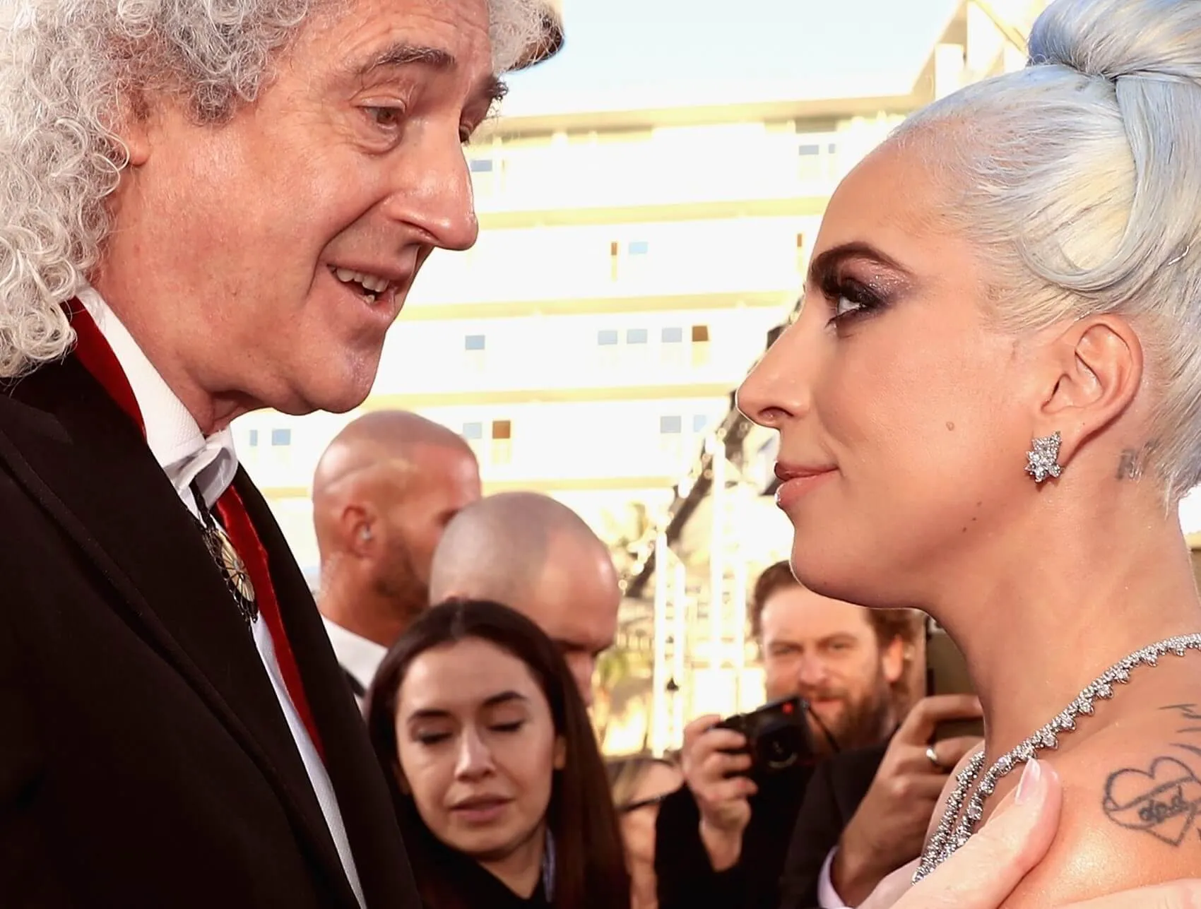 Queen's Brian May and Lady Gaga looking at each other