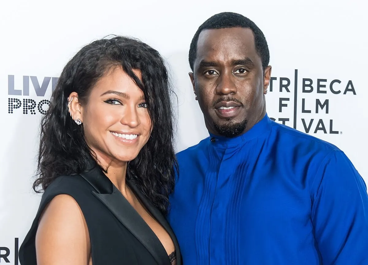 Cassie and Sean 'Diddy' Combs posing at the 'Can't Stop, Won't Stop: The Bad Boy Story' Premiere while wearing a black dress and blue outfit respectively.