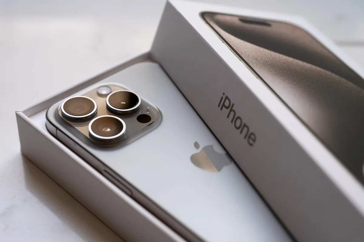 In this photo illustration a brand new Apple iPhone 15 pro titanium is displayed with box and packaging