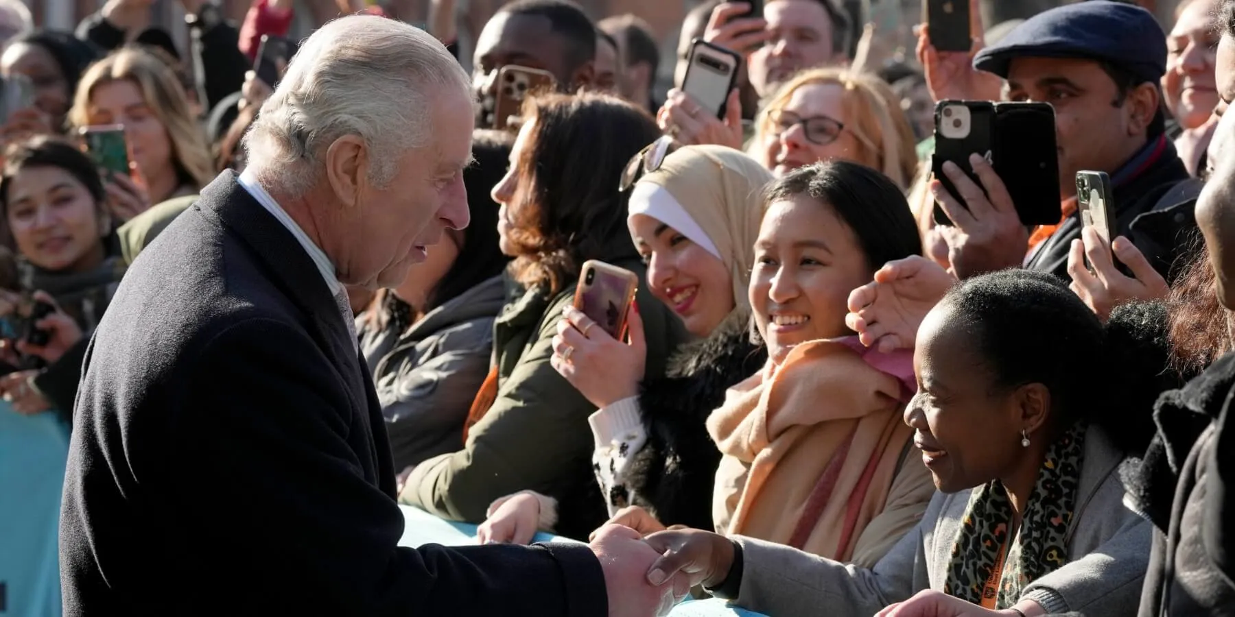 King Charles shaking hands with the public