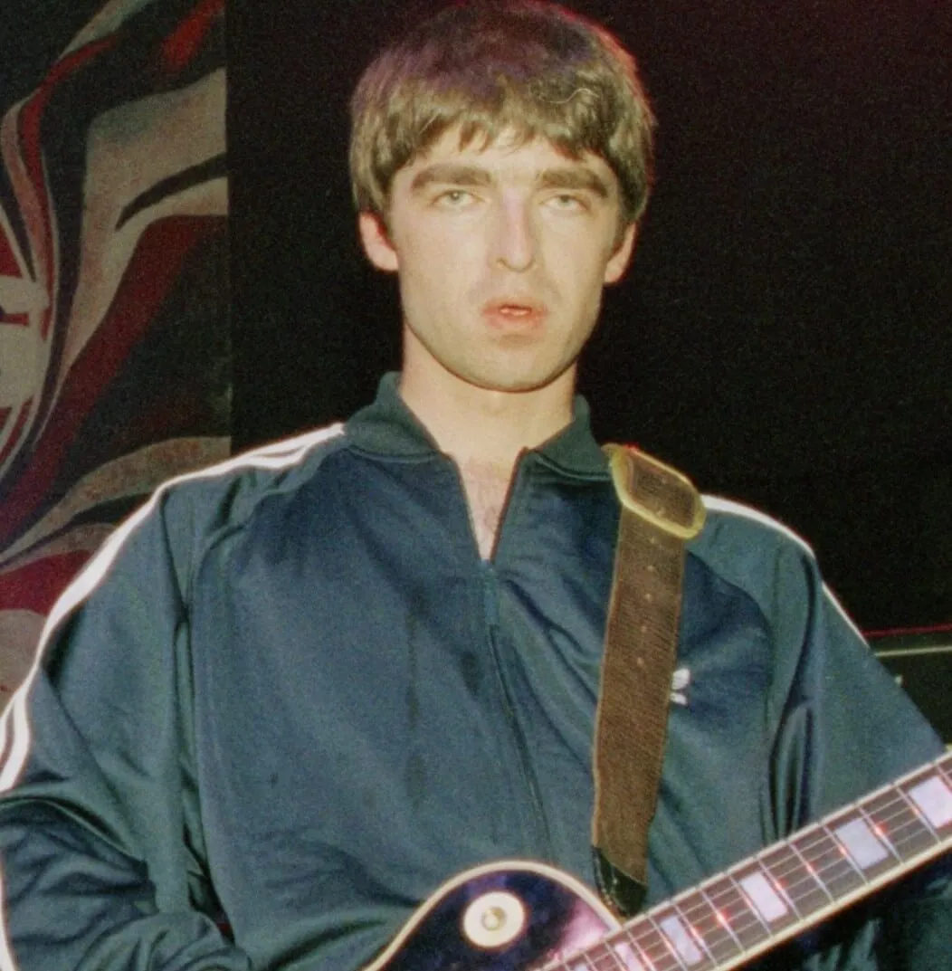 Oasis' Noel Gallagher holding a guitar