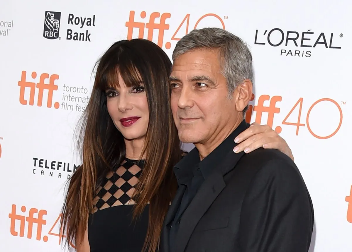 Sandra Bullock and George Clooney posing together at the premiere of 'Our Brand Is Crisis'.