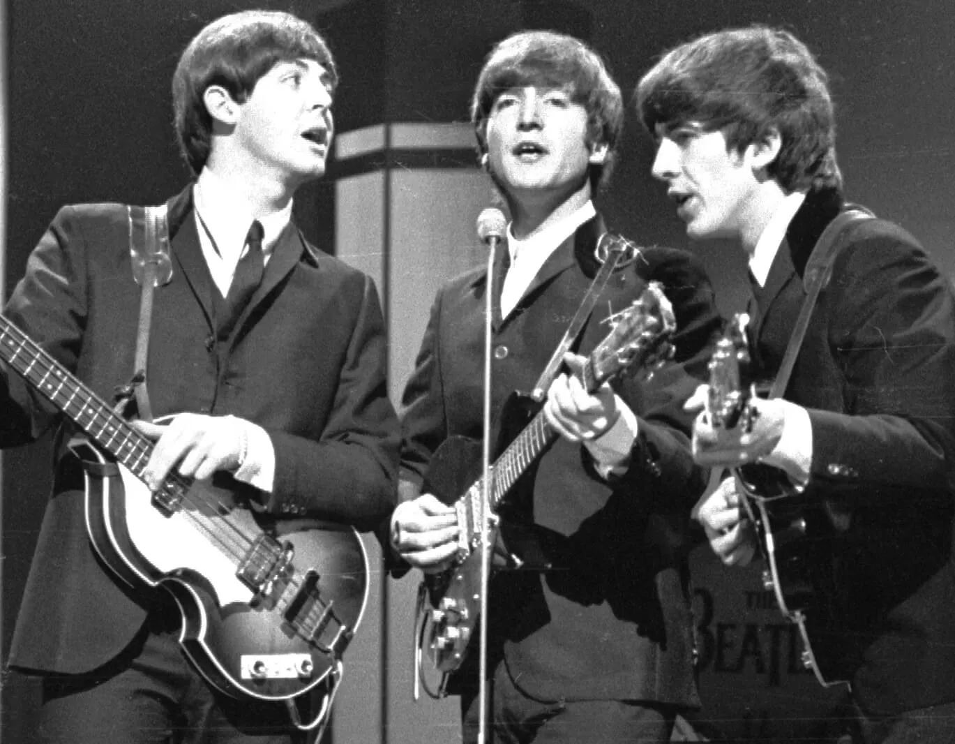 The Beatles' Paul McCartney, John Lennon, and George Harrison wearing suits