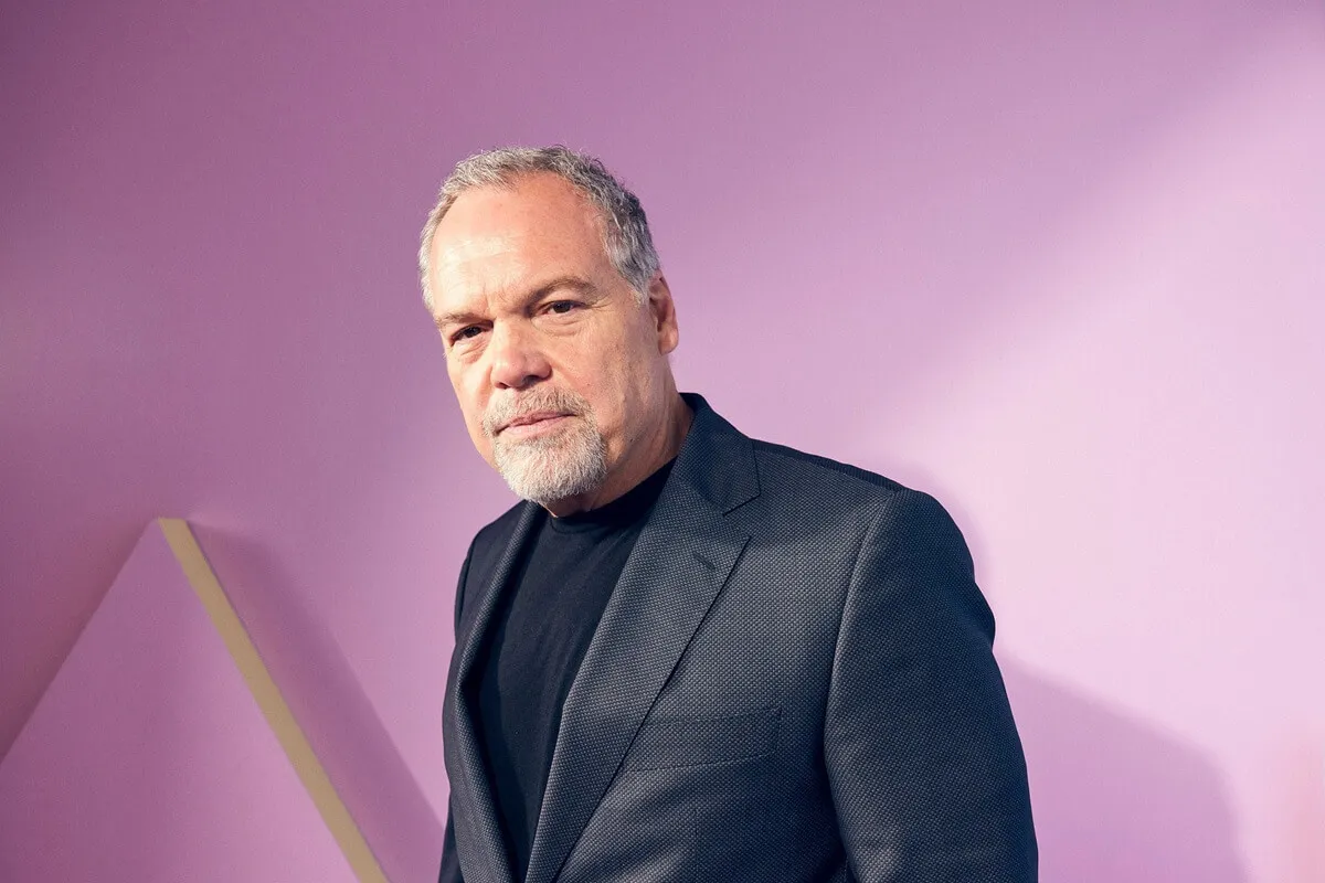 Vincent D'Onofrio poses in the IMDb Official Portrait Studio at D23 in a black suit.