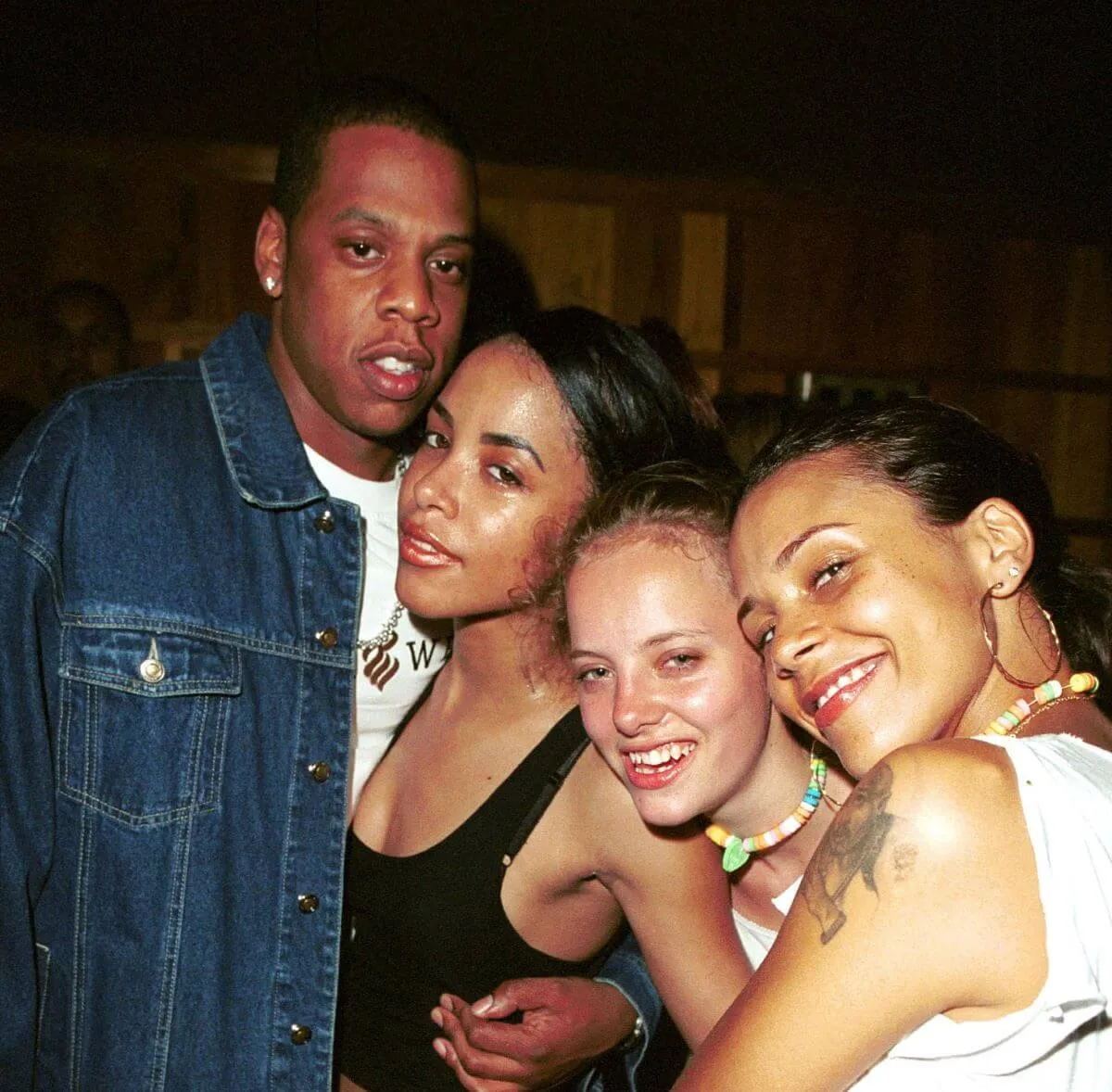 Jay-Z stands with his arm around Aaliyah. They are also with Bijou Phillips and Kidada Jones.